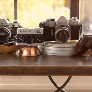 vintage cameras and film on a table