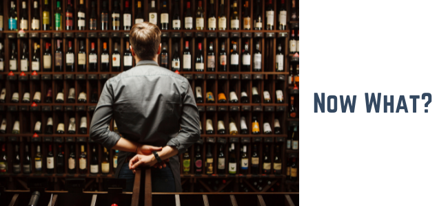man contemplating wine choices